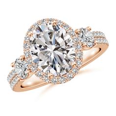 a rose gold engagement ring with three diamonds on the band and an oval center stone