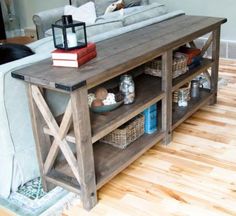 the table is made out of wood and has an entertainment center on one side with shelves