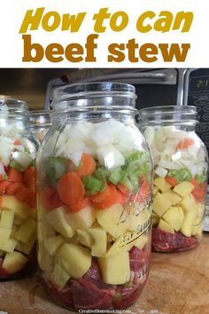 four mason jars filled with food sitting on top of a wooden table