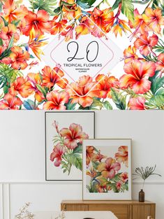 the tropical flowers wallpaper mural is displayed in front of a table with two pictures on it