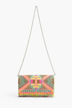 Clutches are all the rage, neons are hotter than ever, so what better way to stay on trend than to combine the two? Our Impala Aztec Clutch is a totally on trend clutch in hot neons with silver details in a super cool flap clutch shape with a totally handy removable cross body strap. Elaborate hand beaded detail adds that effervescent, over-the-top, boho chic detail. The best part about this bag, it can be worn as a crossbody or clutch by changing the strap! Talk about a two for one winner! Whet Multicolor Clutch For Evening In Spring, Trendy Summer Party Clutch, Spring Party Trendy Clutch, Trendy Multicolor Clutch For Spring, Trendy Spring Party Clutch, Multicolor Summer Festival Clutch, Bohemian Multicolor Summer Clutch, Festival Beaded Clutch Bag, Multicolor Woven Bohemian Clutch