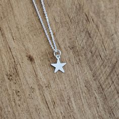 Solid .925 Sterling Silver Star minimalist Necklace. This adorable TINY star charm necklace features a simple, flat star that measures 11mm. Makes a great gift for the stargazer or superstar in your life. Tiny star Charm comes attached to a well-made, 0.8mm Sterling Silver Cable or Box chain in the length of your choice (you choose the style and the length at checkout) USA-made, stamped 925. Comes in a small gift box ready for gift-giving Everyday Star Charm Necklace, Minimalist Star Charm Pendant Necklace, Tiny Star Shaped Minimalist Necklaces, Tiny Star Minimalist Necklaces, Minimalist Tiny Star Necklaces, Sterling Silver Necklace With Starfish Charm, Minimalist Star Necklace For Everyday, Silver Star Print Necklace, Silver Necklace With Star Print For Gift