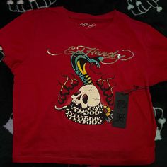 Dark Red Ed Hardy Crop Top Shirt.. It’s Not A Bright Red My Camera Couldn’t Accurately Show The Color. Brand New With Tags Never Worn Size Medium Trendy Red Cotton Shirt, Red Cotton Trendy Shirt, Edgy Red Short Sleeve Top, Trendy Fitted Red Shirt, Edgy Red Summer Tops, Edgy Red Summer Top, Fitted Red Top In Edgy Style, Edgy Red Graphic Print Top, Edgy Red Top With Graphic Print