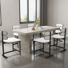 a dining table with six chairs and a vase on the table in front of it