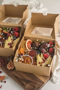 two boxes filled with different types of food