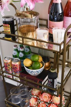 a gold bar cart filled with drinks and snacks