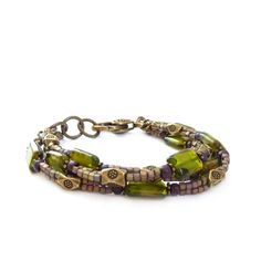 Triple-strand bohemian bracelet. I used Czech glass rectangle beads in an exceptional shade of olive green and added small metallic seed bead cubes that have a wonderful shimmer. Detailed bronze spacer beads compliment the colors and a chunky bronze lobster clasp ties it all together.  * Adjustable - 7 1/4 to 8" (18 to 20cm) long Your bracelet will arrive in a gift box.Browse more of my handmade bracelets here:http://etsy.me/1dvQHuzSHOP ENTRANCE:http://www.etsy.com/shop/RockStoneTreasuresThanks Bohemian Double Strand Bracelet With Colorful Beads, Bohemian Multi-strand Bracelets With Large Beads, Bohemian Czech Glass Beads Bracelet, Bohemian Jewelry With Large Rectangular Beads, Green Bohemian Multi-strand Beaded Bracelets, Bohemian Hand-strung Double Strand Bracelets, Bohemian Double Strand Hand-strung Bracelets, Bohemian Czech Glass Bracelets With Spacer Beads, Bohemian Double Strand Hand Wrapped Bracelets