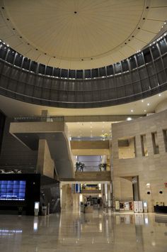 the inside of a large building with lots of windows and lights on it's ceiling