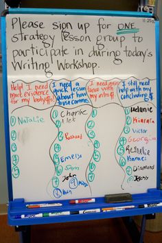 a white board with writing on it in front of a blue easel that says please sign up for one strategy reason group to write in