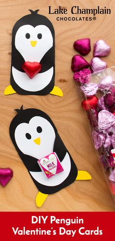 valentine's day crafts for kids with penguins and hearts on the table, one penguin is holding a candy bar