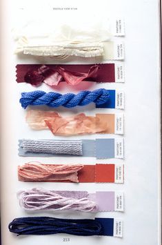 an open book with several different colored ribbons on it's pages, including one for each color