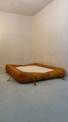 an inflatable mattress sitting on the floor next to a wall with two lamps