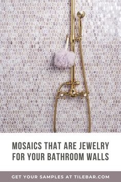 a bathroom with gold fixtures and mosaics that are jewelry for your bath room walls