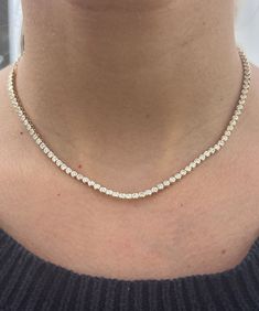 A classic tennis necklace for any occasion. This 3.50 ct of diamonds are bezel set on our classic Tennis Choker chain for an adjustable style. The perfect piece to start layering! 14k Yellow Gold or White Gold 3.50ct tw Necklace, 8.5" of diamonds with 6" of adjustable rings Diamond Color: F/G, Clarity: SI1 Made to Order. Lead time is 2-4 weeks. Benefits of Solid 14k Gold Jewelry Most loved for its durability and longevity Can be worn daily and requires less maintenance and care than plated, verm Classic Cubic Zirconia Tennis Necklace With Bezel Setting, Classic Tennis Necklace With Bezel Setting, Diamond Tennis Necklace With Bezel Setting As Gift, Classic Tennis Necklace With Bezel Setting For Anniversary, Classic Bezel Set Tennis Necklace For Anniversary, Classic Bezel Set Round Tennis Necklace, Classic Round Bezel Setting Tennis Necklace, Round Bezel Set Tennis Necklace For Anniversary, Choker Chain