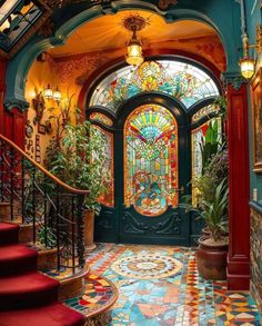 an ornate entryway with stained glass windows and red steps leading up to the second floor