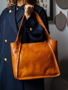 This handmade leather bag is made with 100% natural full grain leather which is tanned with all natural materials. There is no chemical materials in this leather. This bag is handmade in our studio in Milan. The lining is 100% cotton and it is easy to clean. The bag has one middle divider which is a big zipped pocket. There is One smaller zipped pocket in one side and 2 small open pocket at the other side of the bag. All the bags will come with a cotton dust bag which can protect the leather and Leather Bag Handmade, Brown Leather Tote Bag, Handmade Leather Bag, Trendy Jackets, Black Leather Tote Bag, Bag Elegant, Brown Leather Totes, Black Leather Tote, Leather Bag Women