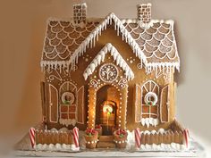 a gingerbread house with icing and candy canes