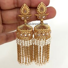 Long Gold Plated Polki Jhumka/Polki stone Jhumka/Indian Jewelry/Pakistani/Punjabi/Indian/Statement earring/Bridal earring/Indian wedding Antique Jhumkis With Gold Plating Height = 75 mm || Width = 28 mm Trendy Design Antique Earring Lightweight and elegant Can be paired with any dress Closure: Pushback This is 100% Handmade jewelry. So Color, shades, texture displayed may slightly vary from the actual product due to digital image limitations. We request you to consider these minor variations. Pl Bridal Earrings With Latkans For Navratri Wedding, Stone Work Jhumkas For Wedding, Chandbali Jhumkas For Wedding And Navratri, Temple Jewelry Stone Work Danglers For Wedding, Wedding Chandbali Jhumkas For Navratri, Cutdana Jhumkas For Navratri Wedding, Wedding Jhumkas With Intricate Design For Eid, Wedding Jhumkas For Eid With Intricate Design, Wedding Temple Jewelry Danglers With Cutdana