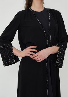 Embrace timeless elegance with this stunning black abaya, featuring intricate rhinestone embellishments along the front and cuffs. Designed for the modern woman who values both modesty and style, this abaya is perfect for special occasions, religious events, or everyday wear. The flowing silhouette ensures comfort and grace, while the shimmering details add a touch of glamour. Pair it with your favorite hijab and accessories to complete your look. Color: Black Details: Rhinestone embellishments Embellished Abaya, Black Abaya, Islamic Dress, Rhinestone Embellishments, Dress Clothes For Women, Favorite Things Gift, Modern Woman, Timeless Elegance, Custom Sizing