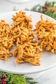 no bake butterscotch haystacks on a white plate with evergreen sprigs