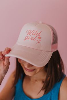 These trucker hats are our new favorites, and they will be yours too! Each style of hat has an adjustable band. Wear them with your hair down or up, and it will instantly make any outfit complete. This hat is pink with, "Wild Girl" printed in darker pink, colored text. Trendy Adjustable Visor Snapback Hat, Fun Summer Trucker Hat With Curved Bill, Summer Trendy Trucker Hat With Curved Bill, Trendy Summer Trucker Hat With Curved Bill, Fun Pink Baseball Cap For Spring, Spring Beach Trucker Hat, 5-panel, Cute Snapback Baseball Cap For Summer, Trendy Pink Baseball Cap For Summer, Trendy Adjustable Trucker Hat With Curved Brim