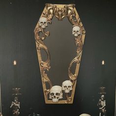 there is a vanity with skulls on it and a mirror in the corner behind it