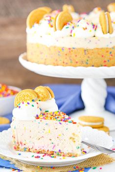 a slice of cake with white frosting and sprinkles on a plate