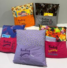 six pillows with different designs on them sitting next to each other in front of a wall