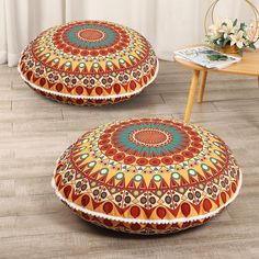 two round floor cushions with colorful designs on them