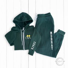 Show your appreciation with this custom zip-up hoodie and jogger set designed as the perfect cheer coach gift. Personalize it with their name and customize design colors for a thoughtful thank you gift. Available in unisex sizes XS to 2XL. ♥PIECES SOLD SEPARATELY OR AS 1 ZIP UP+JOGGER SET * IF YOU WISH TO MAKE ANY CHANGES TO THE ZIP UP DESIGN OR ADD ON TO SLEEVE OR BACK, PLEASE ADD DESIGN UPGRADE AVAILABLE HERE: https://rb.gy/dk7ni  TO SEE MY STOREFRONT FOR MORE ITEMS, GO HERE 👉🏼 https://www.e Cheer Hoodies, Custom Zip Up Hoodie, Cheer Coach Gifts, Cheer Coach, Add Design, Cheer Coaches, Coach Gift, Cheer Mom, Coach Gifts