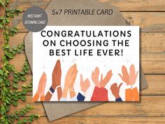 congratulations card for the best life ever with hands on it and greenery in the background