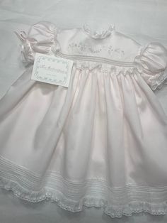 "Please Contact Before Ordering to Avoid Scheduling Conflicts. Toddler High-Yoke Gown Offered in Sizes 12-24 months Yoke Detail The front yoke features hand-embroidery just above a single row of French Lace Insertion. The back yoke also has the single row of Lace Insertion; the Centerback Button Band closes with MOP Buttons.  The Neckline is finished with Swiss Entredeux and gathered Lace Edging. The Yoke is 'framed' with gathered Lace Edging.  Sleeve Detail The short, puff sleeves are set into Lace Insertion, Mop Buttons, Baby Christening Dress, Bachelor Apartments, Blessing Gown, Aesthetic Outfits Y2k, Baby Heirloom, Heirloom Dresses, Baby Doll Pattern