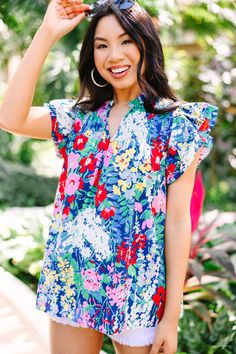 This colorful floral blouse is sure to make you stand out from the crowd! With its vibrant color palette and smocked detailing, this blouse is the perfect way to express your unique style and let your personality shine. This blouse features short sleeves, ruffle detailing, a split v-neck, and a vibrant floral print.  Material has no amount of stretch.Cindy is wearing the small. Vacation Blouse With Butterfly Sleeves And Floral Print, Butterfly Sleeve Blouse With Floral Print For Vacation, Summer Floral Print Blouse With Butterfly Sleeves, Summer Butterfly Sleeve Blouse With Floral Print, Spring Floral Print Blouse With Butterfly Sleeves, Multicolor Floral Print Flutter Sleeve Tops, Multicolor Floral Print Top With Flutter Sleeves, Spring Multicolor Tops With Ruffle Sleeves, Multicolor Floral Print Tops With Flutter Sleeves