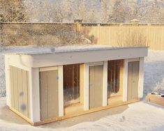 a dog house in the middle of winter with snow falling on it's roof