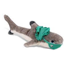 a stuffed animal that is laying down on its back with a green scarf around it's neck