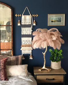 a bedroom with blue walls and an ostrich lamp