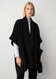 One of the most versatile pieces of the season, this poncho feels like a blanket, but with the fit of an oversized cardigan. The sleeves are loose and fall just over each shoulder, and the style features generous patch pockets that make for the perfect place to warm those fingers on colder days of the year. Throw on over a dress or layer on top a long-sleeve shirt or sweater. This poncho has been designed to fit to a wide range of body types, and is offered in a single size to flatter all. Detai Open Poncho Outfit, Oversized Chic Shawl, Chic Oversized Cashmere Cape, Chic Oversized Poncho Cape, Chic Oversized Cape Poncho, Chic Oversized Shawl, Chic Cape Shawl For Fall, Chic Fall Cape Shawl, Oversized Cashmere Poncho For Winter