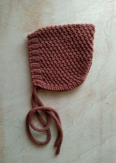 a knitted hat with a string attached to it