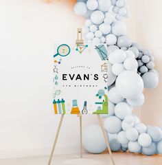 an easel with balloons surrounding it and a sign that says evan's 5th birthday