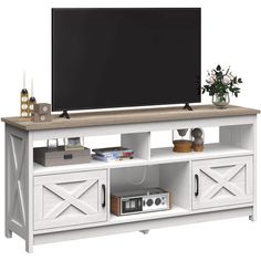 an entertainment center with a flat screen tv mounted on it's sideboard and drawers