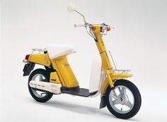 a yellow scooter is shown on a white background with no people around it