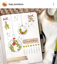 an open planner with christmas decorations on it