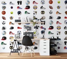 a room with a desk and shelves filled with sports related wall decals on the walls