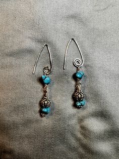 Looking for a stunning pair of earrings to add to your collection? Check out these exquisite V-shaped silver swirl wire earrings, featuring gorgeous turquoise chip beads. Handmade with love and care, these earrings offer a 2 1/2" dangle that will beautifully complement any outfit. Don't miss out on this unique and eye-catching accessory! Turquoise Earrings Dangle, Swirl Earrings, Beads Handmade, Chip Beads, Wire Earrings, Silver Earrings Dangle, Earring Gifts, V Shape, Favorite Jewelry