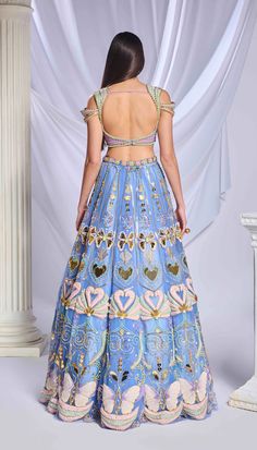 An elegant blue tulle embroidered lehenga adorned with patchwork, special cut acrylics, glass cut beads, pearls, gold chains, sequins and crystals, coupled with a fully embroidered blouse embellished with heart shaped chains, pearls, crystals and glass cut beads. This ensemble is complemented by a matching blue tulle dupatta with an acrylic border and scatters all over for a sophisticated look.From Papa Don’t Preach’s Bring Your Own Fairytale collection. DELIVERY TIMEPlease allow 8-12 weeks for Blue Sequined Sets For Reception, Traditional Hand Embellished Blue Choli, Blue Hand Embellished Choli For Reception, Glamorous Blue Embellished Sets, Blue Sequined Choli For Reception, Multicolor Hand Embellished Lehenga For Reception, Blue Hand Embellished Choli For Party, Blue Hand Embellished Floor-length Choli, Glamorous Blue Sets For Festive Occasions