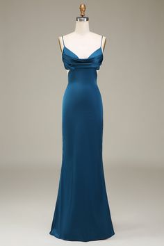 a blue evening gown on display in front of a mannequin's head