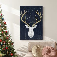 a living room with a christmas tree and a deer head on the wall above it