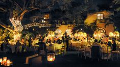 a group of people sitting around tables at night