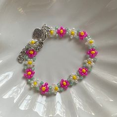 a bracelet with beads and flowers on it