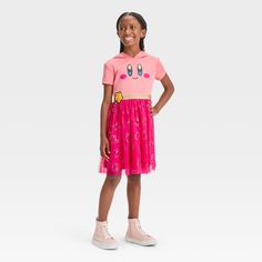 Your child will look oh-so cute in this Kirby Hooded Cosplay Dress. The pullover dress features a short-sleeve bodice in light pink with cute facial features of Kirby on the front, as well as an attached hood. The flouncy knee-length mesh skirt is embellished with shiny Kirby prints on a dark pink backdrop and sports a shiny golden waistband with the cute Popstar logo. Made with soft, stretchy fabric, the cosplay dress offers flexible comfort and allows easy wear with its pullover style. Cute Short Sleeve Dresses For Costume Party, Spring Cosplay Short Sleeve Dresses, Spring Cosplay Dress With Short Sleeves, Short Sleeve Dresses For Cosplay In Spring, Kawaii Short Sleeve Costume Party Dress, Kawaii Short Sleeve Dress For Costume Party, Pink Short Sleeve Dress For Costume Party, Spring Kawaii School Dresses, Cute Pink Dresses With Cartoon Print